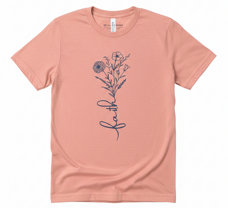 Pink t-shirt with floral design and 'faith' text on a white background