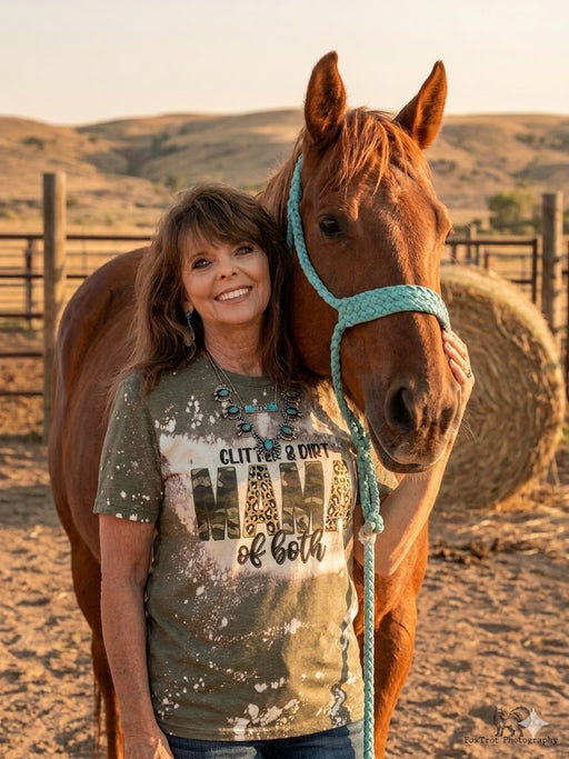 Woman standing next to a horse with a scenic background