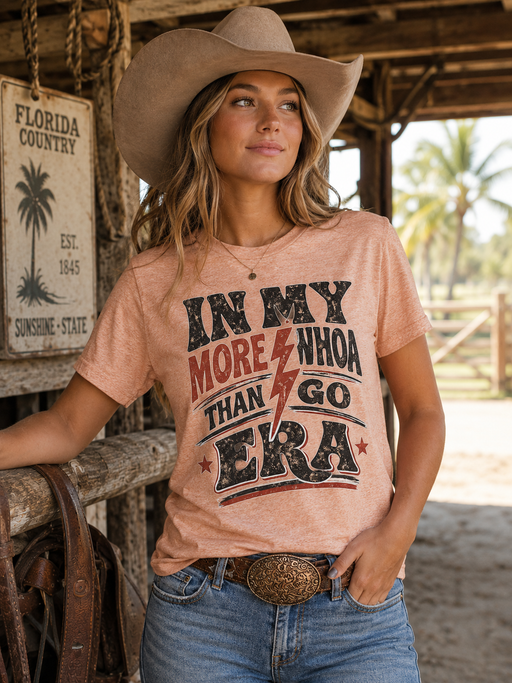 More Whoa Than Go western graphic tee in heather peach with distressed rodeo typography