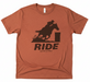 Brown t-shirt with a graphic of a person riding a horse and the word 'RIDE' on a white background.