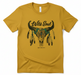 Mustard yellow t-shirt with a bull skull and feathers graphic on a white background